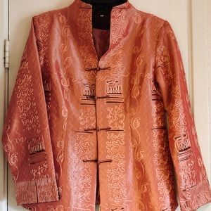 A salmon pink taffeta silk jacket with coiled appliqué and a bohemian vibe.